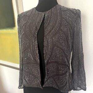 Beaded silk coat with eye hook closure at the collar